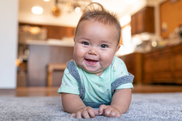 Baby lying on carpet floor | Rockford Floor Covering
